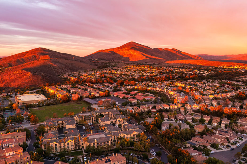 Aerial view of Chula Vista residential neighborhood with mountains at sunset